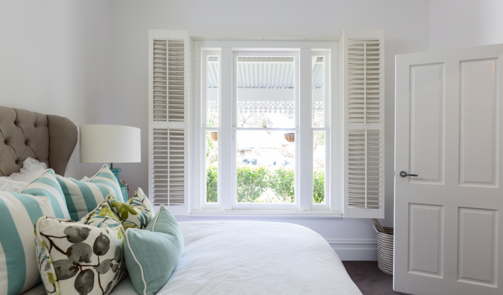 white shutters in a bedroom